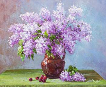 Bouquet of lilacs in a clay jug on the table. Vlodarchik Andjei