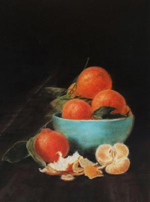 Tangerines in a blue cup