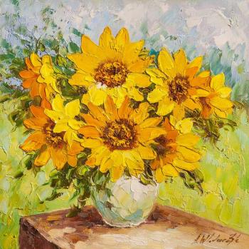 Sunflowers in a vase on the garden background. Vlodarchik Andjei