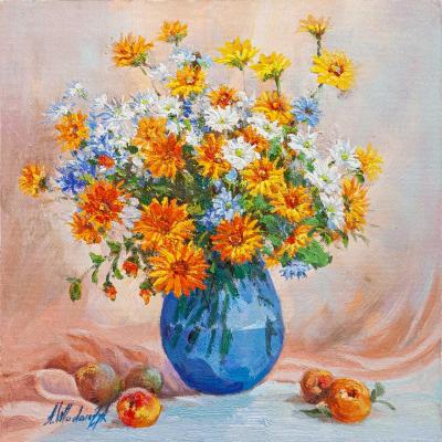Marigolds and cornflowers in a blue vase