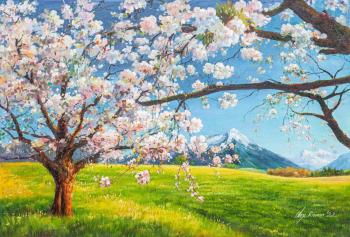 Blossoming apple tree against the backdrop of mountains