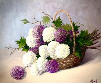 Still life in a basket with a decorative onion and viburnum "bulldenezh"