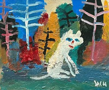 A white cat in an autumn forest