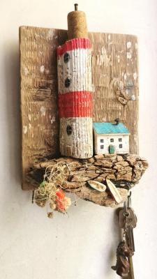 The key keeper with a lighthouse, a house and boats