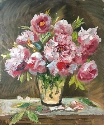A bouquet of peonies in a glass vase