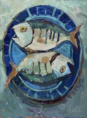 Fishes on a blue plate. Golub Anna