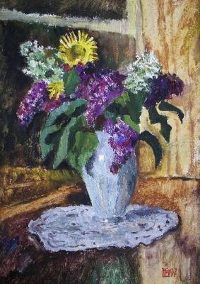 Lilacs and yellow chamomile in a white vase