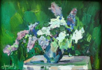 Lilacs on the table in the garden. Artemov Alexander