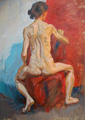A model sitting on a chair with her back to the viewer. Dobrovolskaya Gayane