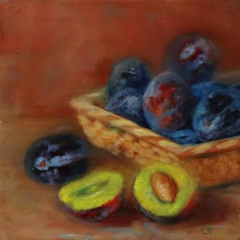 plums in a wicker plate. Razumova Svetlana