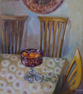 Red vase with tangerines on the table. Yavisheva Tatiana